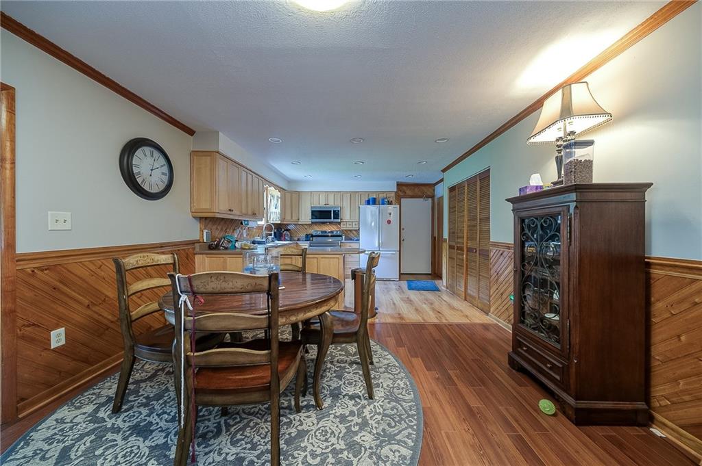 704 Unionville Road Prospect, PA 16052 - Photo 8 of 25 a dining room with furniture and a clock