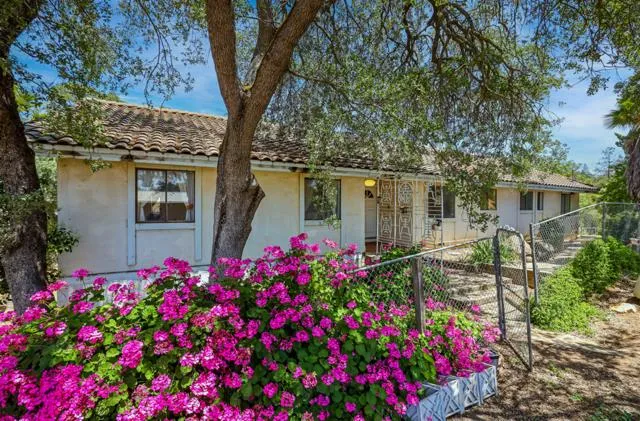 a view of a swimming pool with a patio and a yard