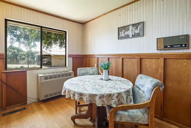 an empty room with a window and a ceiling fan