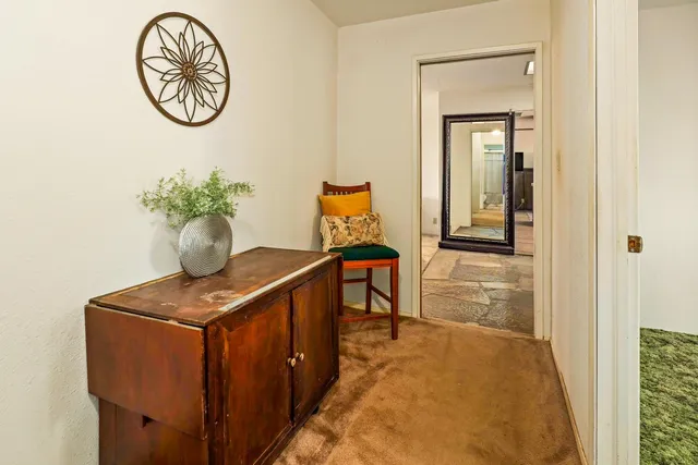 a view of a balcony with floor to ceiling windows and wooden fence