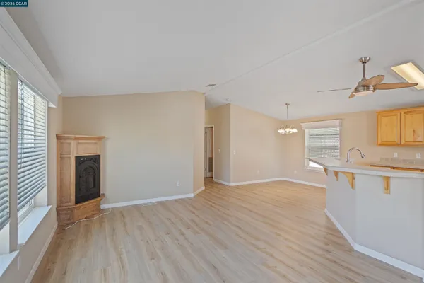 a view of a kitchen with wooden floor and a window