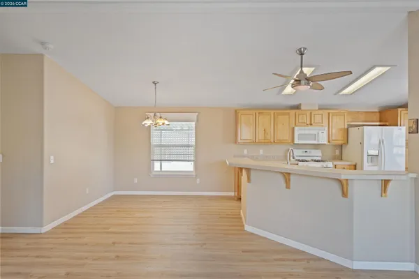 a kitchen with stainless steel appliances granite countertop a sink cabinets and wooden floor