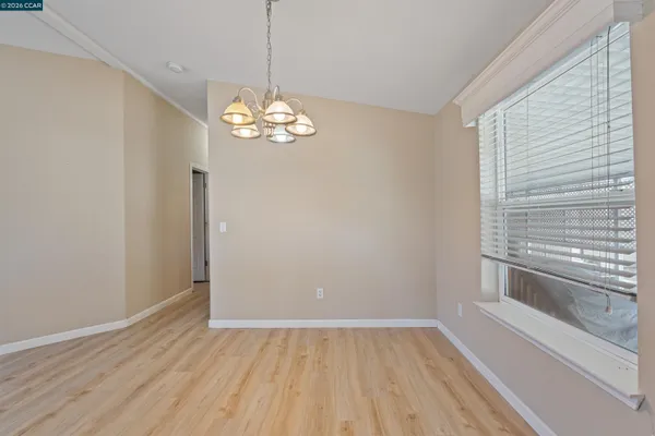 a view of a room with wooden floor and a window