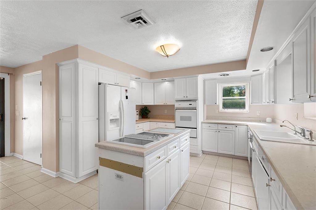 2121 Magnolia Street Pittsburgh, PA 15212 - Photo 13 of 36 a kitchen with a sink stove and refrigerator