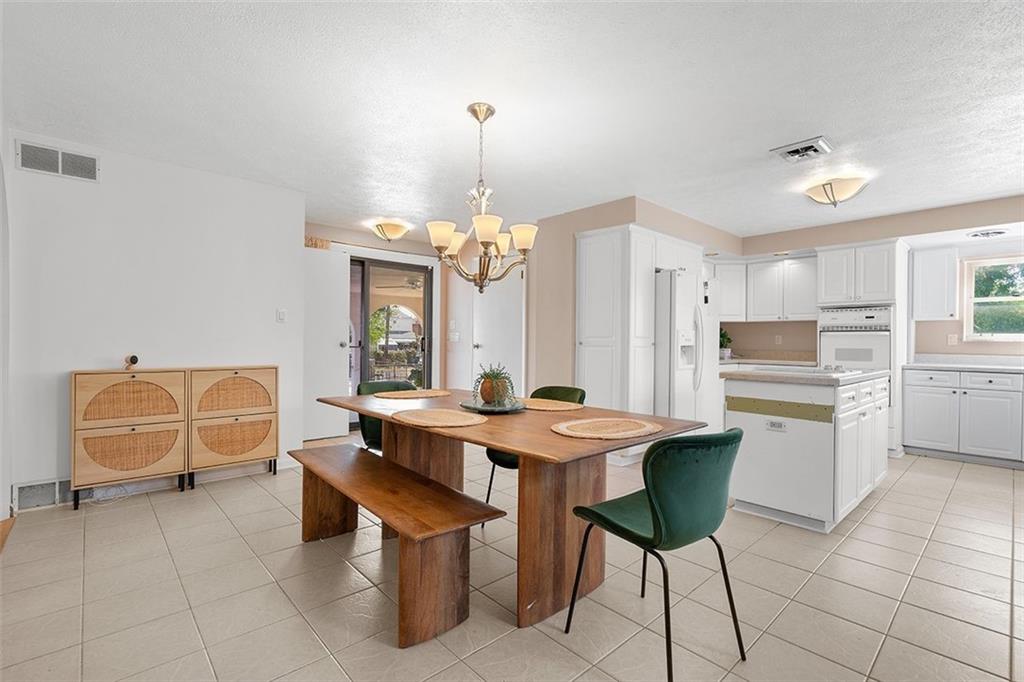 2121 Magnolia Street Pittsburgh, PA 15212 - Photo 14 of 36 a dining hall with stainless steel appliances kitchen island granite countertop a dining table and chairs
