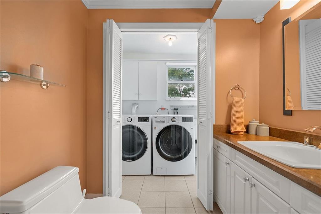 2121 Magnolia Street Pittsburgh, PA 15212 - Photo 15 of 36 a bathroom with a sink a washer and dryer