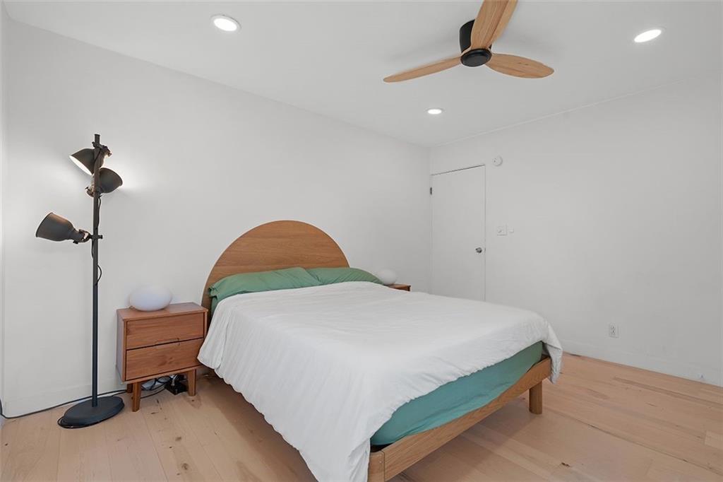 2121 Magnolia Street Pittsburgh, PA 15212 - Photo 19 of 36 a bedroom with a bed and a chandelier