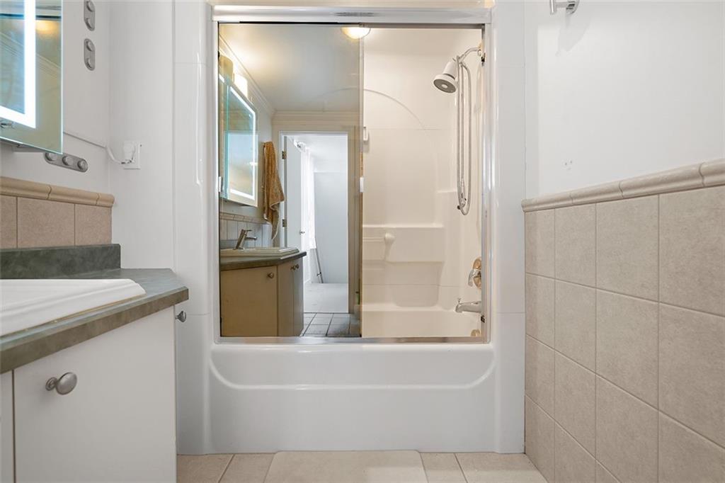 2121 Magnolia Street Pittsburgh, PA 15212 - Photo 24 of 36 a bathroom with a granite countertop sink and a mirror