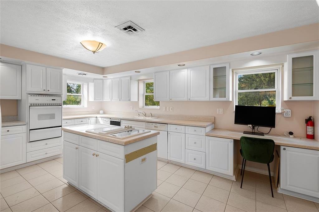 2121 Magnolia Street Pittsburgh, PA 15212 - Photo 10 of 36 a kitchen with white cabinets appliances and a window
