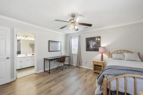 a bedroom with furniture and a wooden floor