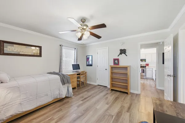 a bedroom with a bed and a chandelier