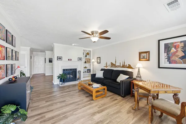 a living room with furniture a fireplace and a book shelf