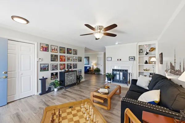 a living room with fireplace furniture and a book shelf