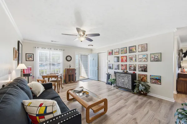 a living room with furniture window and wooden floor
