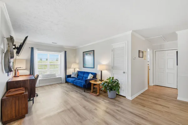 a living room with furniture and wooden floor