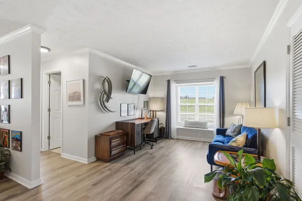 a living room with furniture fireplace and a window