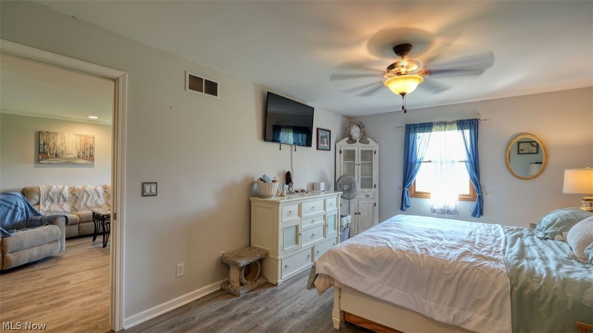 63155 Arrowhead Road Cambridge, OH 43725 - Photo 21 of 50 Bedroom featuring ceiling fan and light wood-type flooring