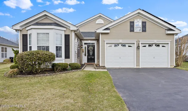 a view of a house with a yard and garage