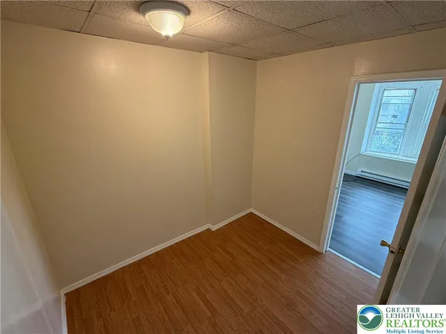 a view of hallway with wooden floor