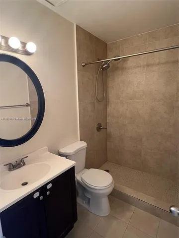 a bathroom with a sink mirror toilet and shower