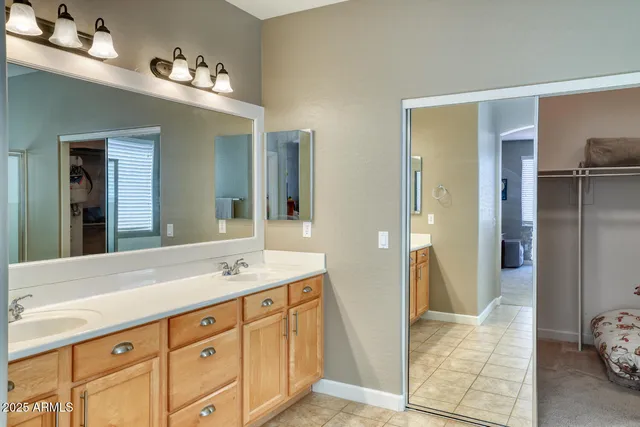 a spacious bathroom with a shower sink and mirror