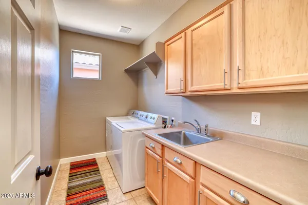 a utility room with sink dryer and washer