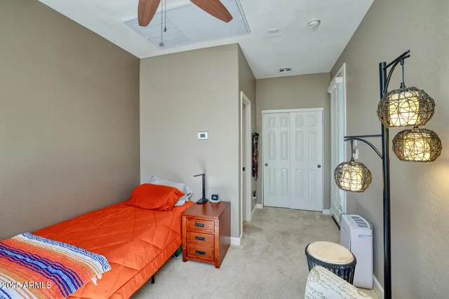 a bedroom with a bed and a chandelier