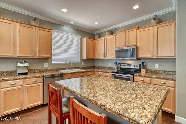 a kitchen with wooden cabinets a sink and a stove