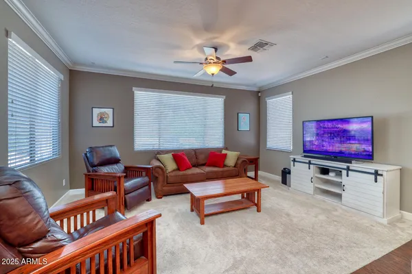 a living room with furniture a rug and a window