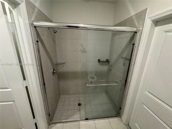 a bathroom with a glass shower door