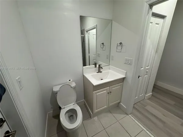 a utility room with a sink and toilet