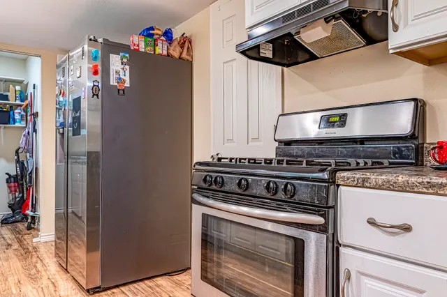 a kitchen with stainless steel appliances granite countertop a stove and a refrigerator