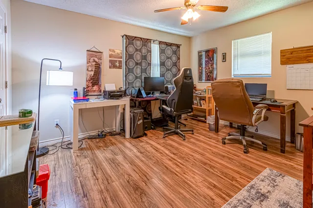 a view of a workspace with furniture and a window