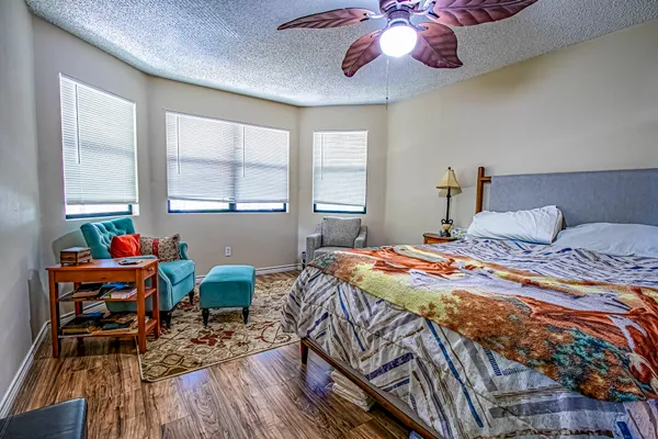a bedroom with a bed and wooden floor