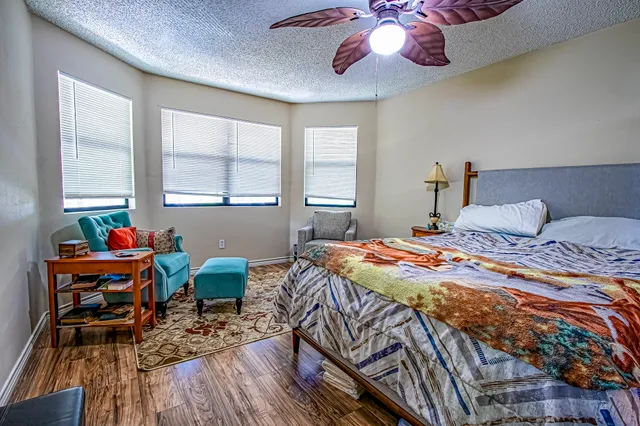 a bedroom with a bed and wooden floor