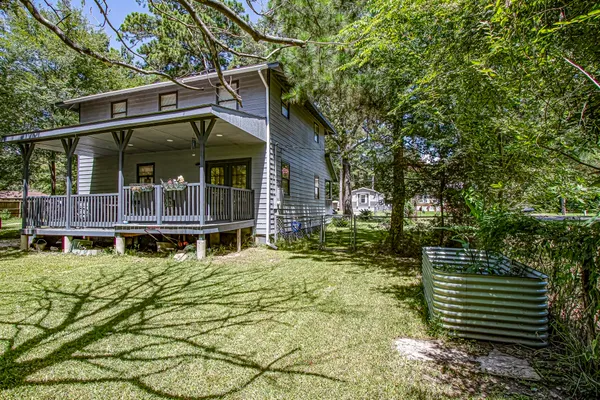 a small house with a trees in the background
