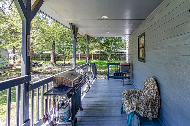 a view of a porch with furniture and wooden floor
