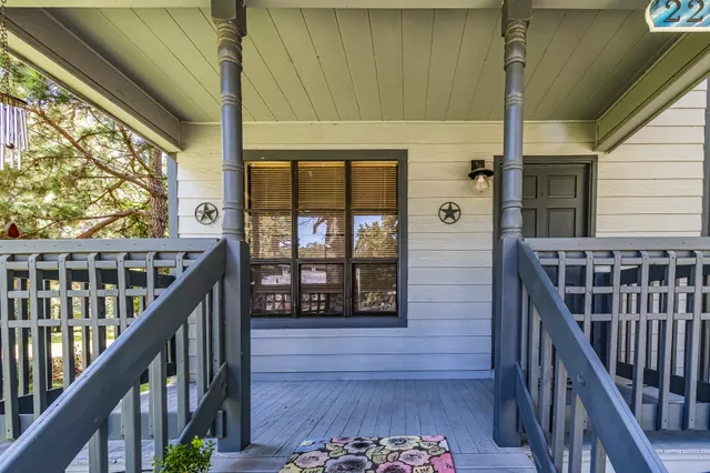a view of balcony with wooden floor and fence