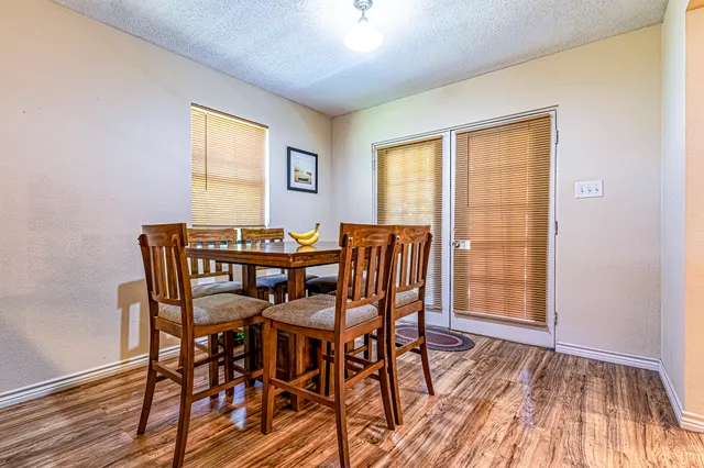 a view of a dining room with furniture and wooden floor