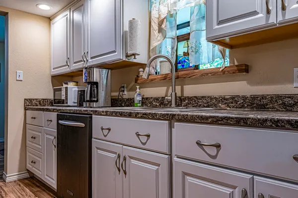 a kitchen with stainless steel appliances granite countertop a sink and cabinets