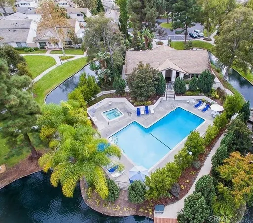 an aerial view of residential house with outdoor space and swimming pool
