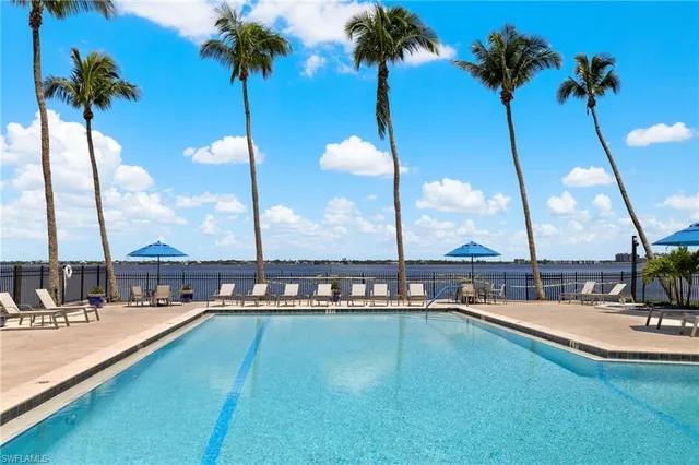 a view of a swimming pool with a lawn chairs