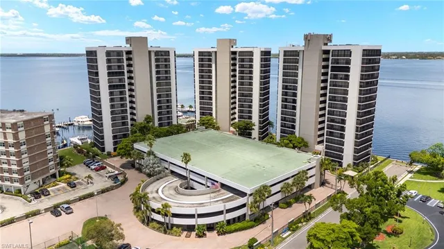 a view of a balcony with chairs and iron fence