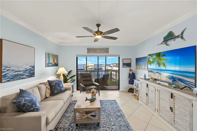 a living room with furniture a floor to ceiling window and a flat screen tv
