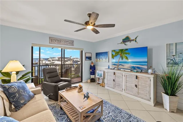 a living room with furniture a flat screen tv and a window