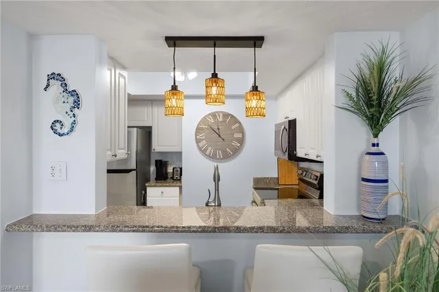 a bathroom with a granite countertop sink a mirror and shower