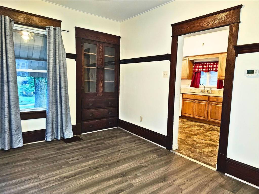 1056 Adams Street New Castle, PA 16101 - Photo 11 of 21 an empty room with wooden floor mirror and windows