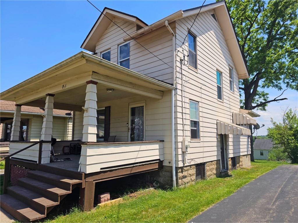 1056 Adams Street New Castle, PA 16101 - Photo 5 of 21 a view of a house with a small yard and a large tree