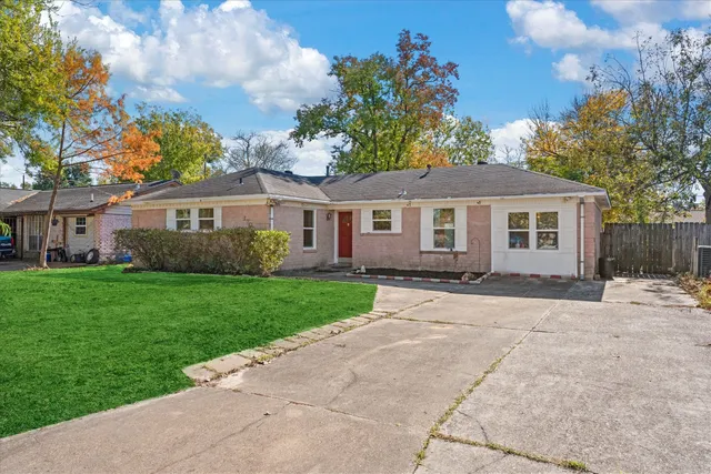 a front view of a house with a garden and yard