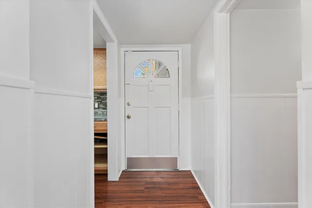 a view of front door with wooden floor
